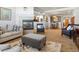 Inviting living room with a fireplace, modern furniture, and an open floor plan with a view of the dining room at 22647 Hopewell Ave, Parker, CO 80138