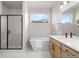 Elegant bathroom featuring a soaking tub, a frameless shower, and a double sink vanity at 4888 Noris Ave, Morrison, CO 80465