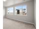 Bright bedroom with large windows offering neighborhood views and ample natural light at 4888 Noris Ave, Morrison, CO 80465