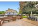 A backyard with a wooden deck, and large green tree at 13123 Spica Dr, Lone Tree, CO 80124