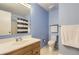 This bathroom features a blue wall, and white shower curtain at 13123 Spica Dr, Lone Tree, CO 80124