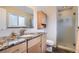 This bathroom features granite countertops, sleek cabinets, and glass shower at 13123 Spica Dr, Lone Tree, CO 80124