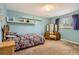 This bedroom features a paisley comforter, matching dresser with vanity, and light blue walls at 13123 Spica Dr, Lone Tree, CO 80124