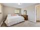 This bedroom features neutral colors, carpeted floors, and a matching wood dresser and window at 13123 Spica Dr, Lone Tree, CO 80124