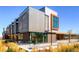 Modern commercial building exterior featuring brick, metal accents, outdoor seating and professionally landscaped areas at 13123 Spica Dr, Lone Tree, CO 80124