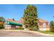 Clubhouse exterior features a welcoming entrance, covered walkway, lush landscaping and classic architectural elements at 13123 Spica Dr, Lone Tree, CO 80124