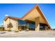 Contemporary building exterior with a unique roof design, stone accents, large glass windows, and manicured landscaping at 13123 Spica Dr, Lone Tree, CO 80124
