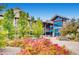 Inviting recreation center with modern architecture, surrounded by colorful landscaping, benches, and lush green trees at 13123 Spica Dr, Lone Tree, CO 80124