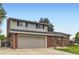 Charming two-story home with a brick facade, attached two-car garage, and manicured front lawn at 13123 Spica Dr, Lone Tree, CO 80124