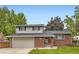 Charming two-story home featuring a brick facade, well-maintained lawn, and an attached two-car garage at 13123 Spica Dr, Lone Tree, CO 80124