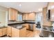 Beautiful kitchen with granite countertops, wood cabinets, stainless steel appliances, and wood floor at 13123 Spica Dr, Lone Tree, CO 80124