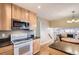Well-lit kitchen with granite countertops, stainless steel microwave, and updated appliances at 13123 Spica Dr, Lone Tree, CO 80124