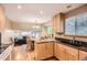 Bright kitchen featuring granite countertops, wood floors, and lots of cabinet space at 13123 Spica Dr, Lone Tree, CO 80124