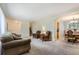 Comfortable living room with carpet, neutral walls and a staircase leading to the upper level at 13123 Spica Dr, Lone Tree, CO 80124