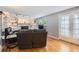 Cozy living room featuring a fireplace, built-in shelves, hardwood floors, and natural light at 13123 Spica Dr, Lone Tree, CO 80124