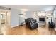 Inviting living room featuring a fireplace, built-in shelving, hardwood floors, and contemporary decor at 13123 Spica Dr, Lone Tree, CO 80124
