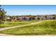 Scenic view of a neighborhood with a golf course, walking path, lush green lawns, and beautifully landscaped homes at 13123 Spica Dr, Lone Tree, CO 80124