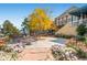 Outdoor patio area with seating, tables, vibrant flowers, and a partial view of a building with classic architecture at 13123 Spica Dr, Lone Tree, CO 80124