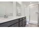 Modern bathroom with double vanity, sleek finishes, and glass-enclosed shower at 1974 S Haleyville Way, Aurora, CO 80018
