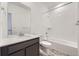 Bright bathroom featuring a shower-tub combo with white subway tile and gray vinyl flooring at 1974 S Haleyville Way, Aurora, CO 80018