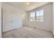 Well-lit bedroom featuring carpet, large windows, and white paint at 1974 S Haleyville Way, Aurora, CO 80018