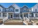 Charming townhouse featuring light blue siding and a well-manicured front yard at 1974 S Haleyville Way, Aurora, CO 80018