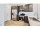 Modern kitchen featuring stainless steel appliances, gray cabinets, and sleek countertops at 1974 S Haleyville Way, Aurora, CO 80018