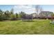 Expansive, green backyard showcasing ample space and a trampoline at 26404 E Caley Dr, Aurora, CO 80016