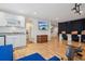 Spacious basement with hardwood floors, kitchenette, and access to the backyard stairs at 26404 E Caley Dr, Aurora, CO 80016
