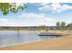 Picturesque lake view featuring a sandy beach, swimming area, and recreational facilities at 26404 E Caley Dr, Aurora, CO 80016