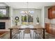 Bright dining room featuring a fireplace, large wooden table, and views of the backyard at 26404 E Caley Dr, Aurora, CO 80016