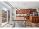 Well-lit dining room with wooden table and adjacent kitchen featuring stainless steel appliances and access to the yard at 26404 E Caley Dr, Aurora, CO 80016