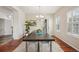 Elegant dining room with hardwood floors, plantation shutters, and a chandelier providing soft lighting at 26404 E Caley Dr, Aurora, CO 80016