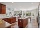 Modern kitchen featuring wood cabinets, a central island, and an open layout perfect for entertaining guests at 26404 E Caley Dr, Aurora, CO 80016