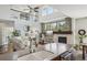Open living space with a kitchen island, fireplace, and large windows filling the room with natural light at 26404 E Caley Dr, Aurora, CO 80016