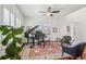 Bright living room featuring a grand piano, hardwood floors, and a ceiling fan for a cozy atmosphere at 26404 E Caley Dr, Aurora, CO 80016