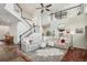 Open living room with high ceilings, a staircase, and a plush sectional sofa creating a comfortable gathering space at 26404 E Caley Dr, Aurora, CO 80016