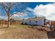 Spacious backyard with a wooden fence and an old brick pile at 1451 S Quitman St, Denver, CO 80219
