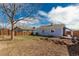 Expansive backyard with wood fence and mature tree, offering ample space for outdoor activities and privacy at 1451 S Quitman St, Denver, CO 80219