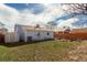 A view of the backyard with a storage shed and a wood fence along the side at 1451 S Quitman St, Denver, CO 80219