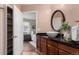 Updated bathroom vanity with a vessel sink, dark countertop, and views into the connected bedroom at 1451 S Quitman St, Denver, CO 80219