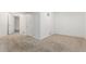 Spacious carpeted bedroom with white walls, multiple doors, and ample space for customization at 1451 S Quitman St, Denver, CO 80219
