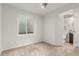 Basement bedroom with beige carpet and a small window that lets in some sunlight at 1451 S Quitman St, Denver, CO 80219