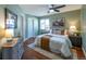 Beautifully appointed bedroom featuring soft green walls, and a large light-filled window at 1451 S Quitman St, Denver, CO 80219