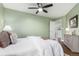 Cozy bedroom showcasing calm, neutral tones, wooden floors, and soft, natural lighting at 1451 S Quitman St, Denver, CO 80219