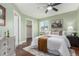 Comfortable bedroom featuring neutral decor, a ceiling fan, and a cozy bed setup at 1451 S Quitman St, Denver, CO 80219