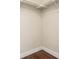 Walk-in closet with wood-look floors and built-in hanging racks offer a functional space at 1451 S Quitman St, Denver, CO 80219