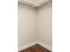 Empty closet with wood flooring, white walls, and simple shelving and supports at 1451 S Quitman St, Denver, CO 80219