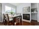 Elegant dining area with a fireplace, natural light, and a stylish table setup perfect for Gathering meals at 1451 S Quitman St, Denver, CO 80219