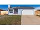 Charming light blue house featuring a two-car garage, new solar panels, and a well-maintained lawn at 1451 S Quitman St, Denver, CO 80219